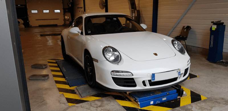 Porsche 911 blanche sur pont dans le garage
